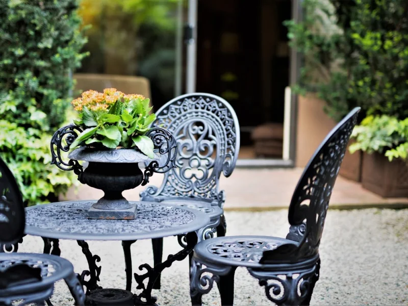 Outdoor garden patio with ornate wrought-iron seating at a tranquil spa venue