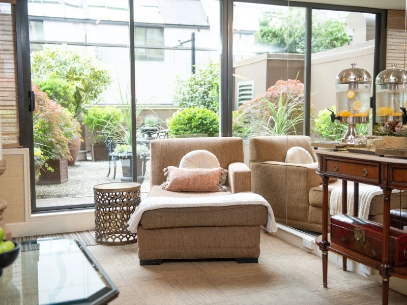 Elegant spa lounge with natural light, garden views, and comfortable seating