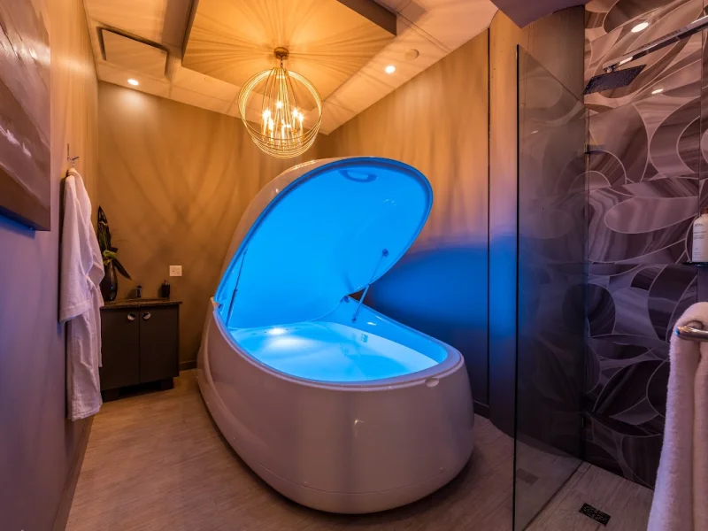 Private floatation spa room with glowing sensory deprivation tank