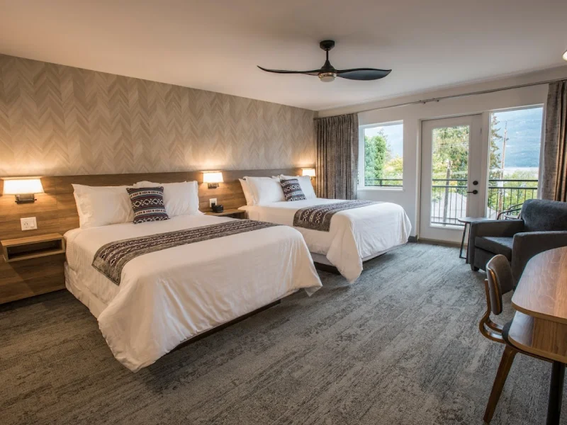 Guest room with two beds, balcony access, and mountain views