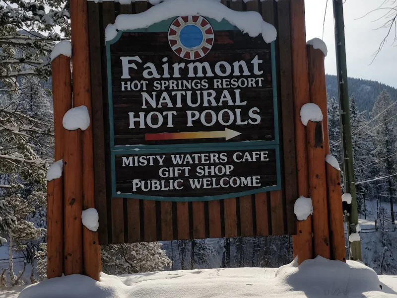 Snowy Fairmont Hot Springs Resort sign welcoming guests to natural hot pools