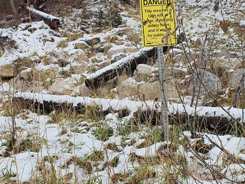 Snowy trail with warning signs at an ecological reserve hot spring area